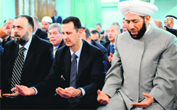 Bashar al-Assad attends the Eid-ul-Fitr prayer in Damascus on Thursday.  AFP
