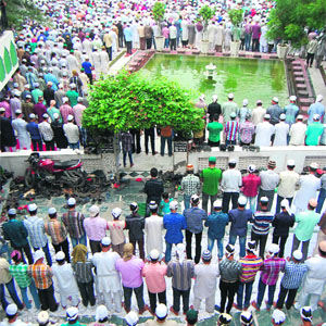 People offer prayers on the occasion of Eid-ul-Fitar at the Kharudin mosque, Hall Bazaar, in Amritsar on Friday.