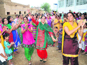 Women celebrate Teej with gaiety at Jaipalgarh village in Bathinda on Friday.