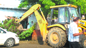 A JCB machine demolishes an unauthorised structure on Rathdhana road in Sonepat on Friday.