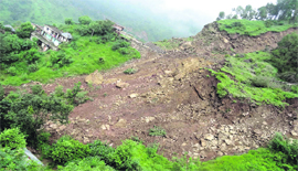 A massive landslide crumbles a hillock at Tamled village in Sarkaghat.