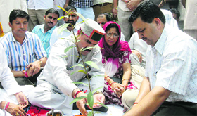 ID Lakhanpal, CPS, plants a sapling at Hamirpur on Friday.