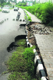 A portion of the road caved in at the University of Jammu on Friday.