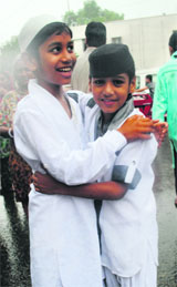 Children greet each other on the occasion of Eid-ul-Fitr in Jammu on Friday. 