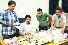 The team of Health Wing of Jammu Municipal Corporation with polythene bags seized from traders in Jammu on Friday. 