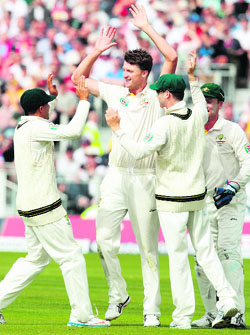 Jackson Bird is congratulated by his team-mates after he removed Alastair Cook. 
