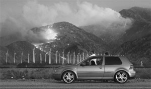 Motorists stop to watch as a fire spreads up the north side of the San Jacinto Mountains near wind turbines at the Silver Fire east of Banning, California on Thursday.