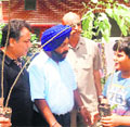 Members of the Punjabi Biradari Welfare Society distribute saplings in Dehradun on Saturday. 