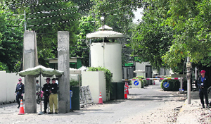 Security personnel guard the entrance of a road leading to the US consulate in Lahore.