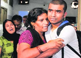 Family members of deceased NIT student Paras console each other at the Civil Hospital in Jalandhar on Saturday