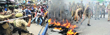 Protesters clash with the police, (right) police personnel trying to douse burning tyres on the National Highway at Nai Basti in Jammu on Saturday. 