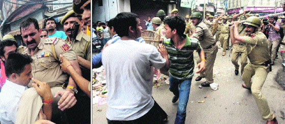 An injured police officer being carried away; protesters clash with the police in the City Chowk area