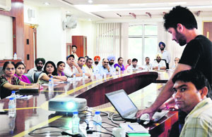 MC officials give a presentation about the registration of births at the MC Zone-D office in Ludhiana on Saturday. 