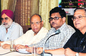 Members of the Ludhiana Sanskritik Samagam speak about the play,"Two to Tango, Three to Jive", during a press conference in Ludhiana.  