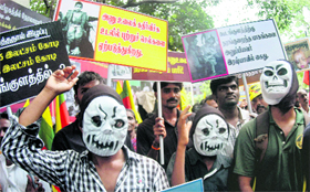 An activist wearing a mask shouts slogans at a protest against the Kudankulam Nuclear Power Project in Chennai on Saturday.