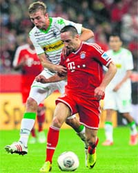 Franck Ribery is tackled by Borussia Moenchengladbach's Christoph Kramer during their league match in Munich on Friday