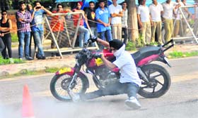 Bikers perform stunts without wearing safety gear during a show organised by the UT police in Sector 10, Chandigarh
