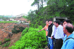 Minister for Housing and Urban Development Sudhir Sharma inspects the landslide area at Terra Lines near Dharamsala on Sunday.