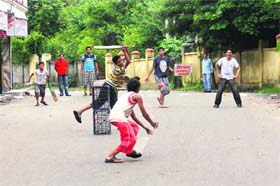 Children play on an empty road in Rehari area