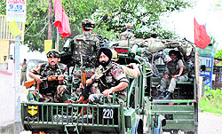 The Army takes out a flag march in the Subhash Nagar area during curfew in Jammu on Sunday