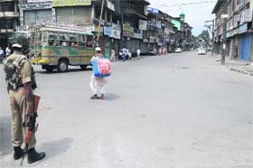 No Restrictions: Amid a strike called by the Hurriyat Conference over Kishtwar violence, a security personnel stands guard at the Budshah Chowk in Srinagar on Sunday
