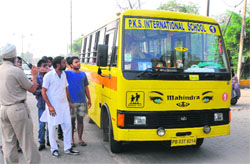 A school bus being stopped from plying in view of the strike against the state government, near Sirhind Canal.