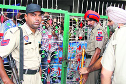 Police personnel outside the locked gate of Teachers Home in Bathinda on Monday. 