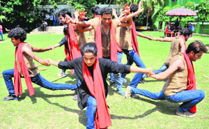 Students of DAV College perform a street play at Sector 10 in Chandigarh on Monday. 