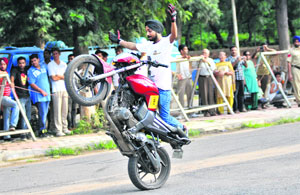 A biker performs a daredevil stunt without wearing safety gear during a show organised by the UT police in Sector 10, Chandigarh, on Sunday. 