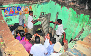 People remove debris from the house after its roof collapsed in Colony No. 4 in Chandigarh on Monday.