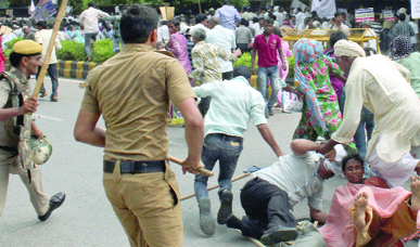 Police personnel lathicharge the activists of Arakshan Bachao Sangharsh Samiti to disperse them during a demonstration, demanding caste-based affirmative action for promotions in government jobs, near Parliament House in New Delhi on Monday.