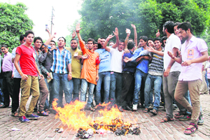 Students belonging to the Aryan group of DAV PG College hold a dharna in Dehradun on Monday in support of their demand for raising the upper age limit for government jobs.