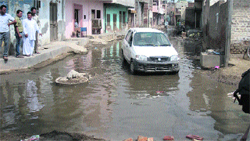 Sewage overflows a street in Gaushala Mohalla at Sirsa on Monday. A Tribune photograph