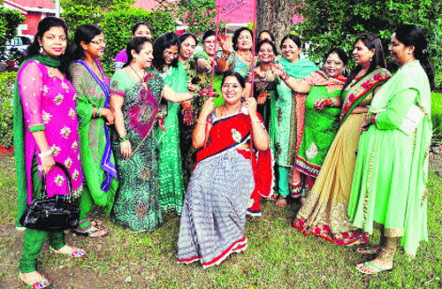 Mayor Renu Bala Gupta (on the swing) celebrates Teej festival with women in Karnal. 