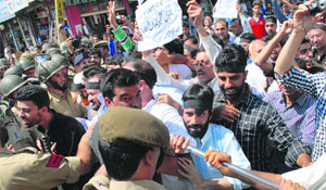 The police stops activists of the Jammu and Kashmir Liberation Front from holding a march in Srinagar on Monday. 