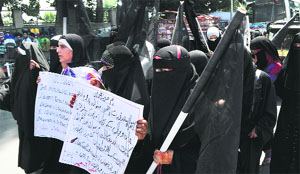 Activists of the Jammu and Kashmir Muslim Khawateen Markaz stage a protest against the Kishtwar violence in Srinagar on Monday. 