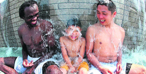 People enjoy a shower in Kofu, Yamanashi prefecture, in Japan on Sunday.