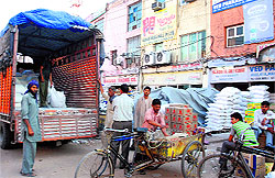 Workers unload a truck at the Grain Market