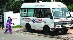 A woman throws a stone at an ambulance at the GMSH, Sector 16, on Tuesday
