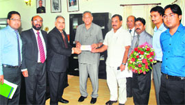 BK Srivastava, Executive Director of Corporation Bank, presents a cheque for 