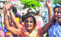 Women hold protest at Bharat Nagar Chowk after the death of an eight-year-old boy in Ludhiana on Tuesday. Tribune Photo: Himanshu Mahajan