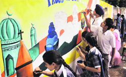 Students paint graffiti on the boundary wall of the police lines in Ludhiana on Tuesday. A Tribune photograph