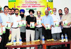 Members of Hind-Pak Dosti Manch and Folklore Resecarch Academy release a souvenir, Paanj Pani  during a seminar on Indo-Pak ties at GNDU in Amritsar on Wednesday