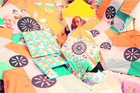Jagmohan Kanojia shows various Independence Day kites with pictures of freedom fighters on the eve of Independence Day in Amritsar on Wednesday