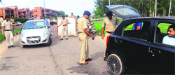 Policemen check vehicles during a special drive on the eve of Independence Day on the road dividing Sectors 50 and 51 in Chandigarh on Wednesday. Tribune photo: Parvesh Chauhan