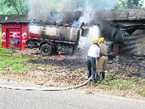 Fire Brigade personnel douse fire near Nurpur on Wedensday. 