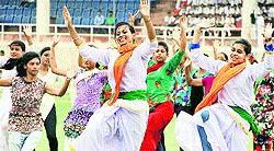 Girls dressed up in Tricolour perform during the full dress rehearsal of I-Day function at Guru Gobind Singh Stadium