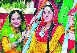Students of the Khalsa Institute of Management and Technology for Women celebrate Teej festival on the college campus in Ludhiana