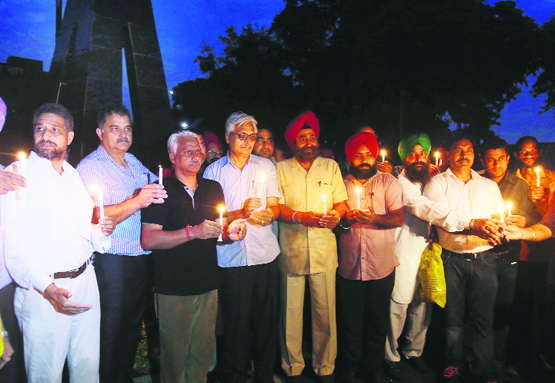 Members of the Hind-Pak Dosti Manch hold a candlelight vigil at the Attari-Wagah border on the eve of the Independence Day on Wednesday.