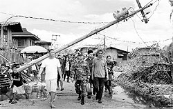 A military official inspects the damage caused by Typhoon Utor at Casiguran town in the Philippines. Utor was the worst typhoon to hit the Philippines this year, killing six persons and displacing 30,000 families. On Wednesday, it struck the south coast of China